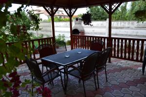 a blue table and chairs on a patio at Pensiunea Alexander in Arad