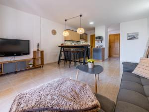 een woonkamer met een bank en een tafel bij Apartment Can Suarez by Interhome in Cala Mendia