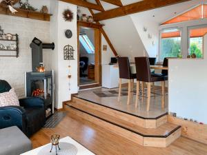 a living room with a table and a fireplace at Apartment Osterloh by Interhome in Hage