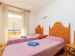 A bed or beds in a room at Apartment Edificio Tamarius by Interhome