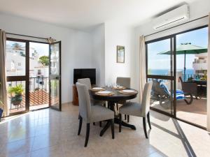 a dining room with a table and chairs at Apartment Vista del Mar by Interhome in Nerja