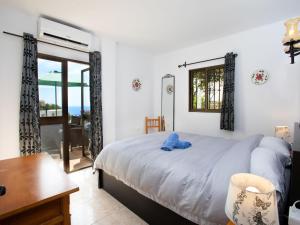 a bedroom with a bed and a desk and a window at Apartment Vista del Mar by Interhome in Nerja