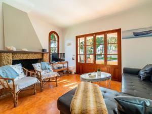 a living room with a couch and a fireplace at Holiday Home Can Xiroia by Interhome in Alcudia +26 photos