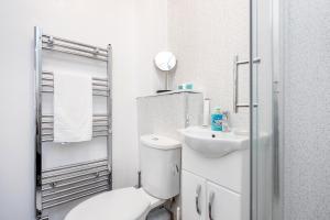 a white bathroom with a toilet and a sink at Beautiful 1-Bed Apartment in London Lewisham in London