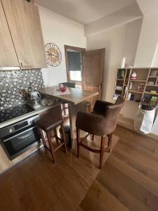 a kitchen with a table and chairs in a room at Vidik Kopaonik in Kopaonik