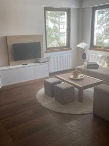 a living room with a couch and a coffee table at Vidik Kopaonik in Kopaonik