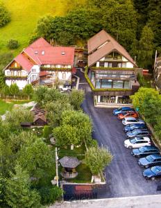 an aerial view of a hotel with cars parked in a parking lot at Pension Mama Cozonacilor in Bran