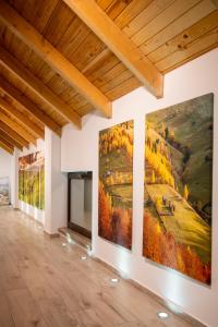 a gallery with three large paintings on the walls at Pension Mama Cozonacilor in Bran