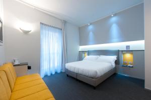 Posteľ alebo postele v izbe v ubytovaní Executive Inn Boutique Hotel + 37 fotografií