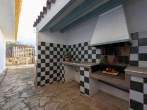 una cucina con piastrelle a scacchi bianche e nere sul muro di Villa Arenal by Interhome a L'Ampolla