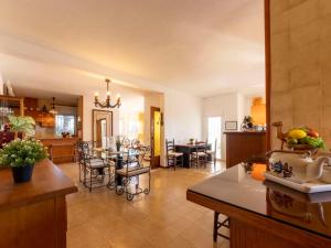 a kitchen and living room with a table and chairs at Holiday Home Arenal by Interhome in L'Ampolla