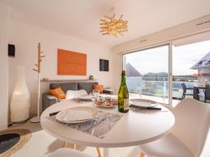 a white table and chairs in a living room with a window at Apartment Le Yacht Club by Interhome in Quiberon