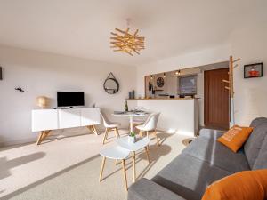 a living room with a couch and a table at Apartment Le Yacht Club by Interhome in Quiberon