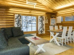 a living room with a couch and a table at Holiday Home Lakka by Interhome in Salla