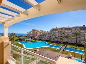 a view from the balcony of a resort with a swimming pool at Apartamento Tamarindo - Ubicación Premium Frente a la Playa con Piscina in Denia