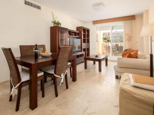 a living room with a dining room table and chairs at Apartamento Tamarindo - Ubicación Premium Frente a la Playa con Piscina in Denia +21 photos