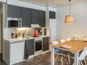a kitchen and dining room with a table and chairs at Holiday Home Lakevillas b1 price includes 4 ski passe by Interhome in Hyrynsalmi