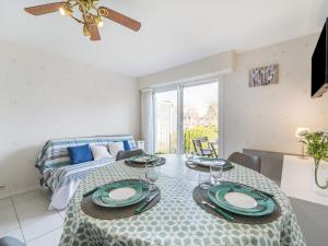 a dining room with a table and a bed at Apartment Les Ecureuils by Interhome in Carnac +16 photos