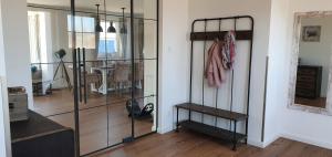 a living room with a glass closet and a dining room at Ferienhaus Strandjuwel in Dranske
