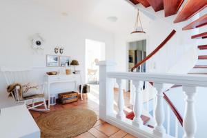 a staircase in a home with white walls and a spiral stair case at Zuhause auf Zeit in Osterode