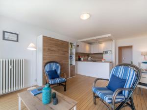 a living room with two chairs and a table at Apartment Les Trois Iles-10 by Interhome in Quiberon