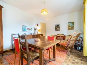 a dining room with a wooden table and chairs at Holiday Home GACHOUNENEA by Interhome in Bidart