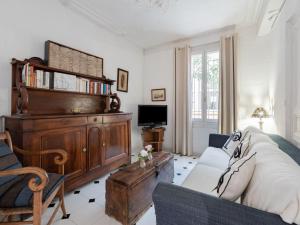 a living room with a couch and a tv at Holiday Home La Maison Theaulon by Interhome in Aigues-Mortes