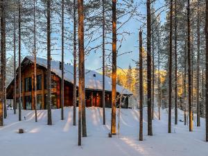 a log cabin in the snow in the woods at Holiday Home Tievachalets 6 b by Interhome in Sirkka