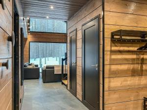 a hallway with wooden walls and a door in a house at Holiday Home Tievachalets 6 a by Interhome in Sirkka