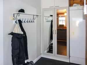 HyrynsalmiにあるHoliday Home Alppikylä 8a paritalo includes two ski l by Interhomeの洋服掛けと鏡付きの部屋