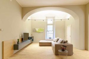 a living room with a couch and a tv at Crociferi Luxury Apartment in Catania