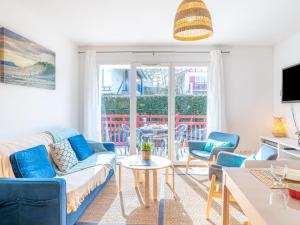 ein Wohnzimmer mit einem Sofa, Stühlen und einem Tisch in der Unterkunft Apartment Les Jardins d'Oihana by Interhome in Bidart