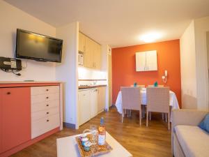a living room with a kitchen and a dining room at Apartment Le Belvédère - V2 013 by Interhome in Agay - Saint Raphael