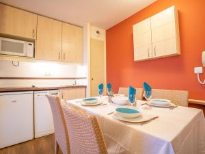 a kitchen with a table with plates and bowls on it at Apartment Le Belvédère - V2 013 by Interhome in Agay - Saint Raphael +44 photos