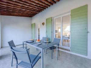 a dining room with a table and chairs at Holiday Home Lou Cepoun by Interhome in Cogolin