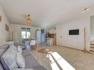 a living room with a couch and a table at Holiday Home Lou Cepoun by Interhome in Cogolin