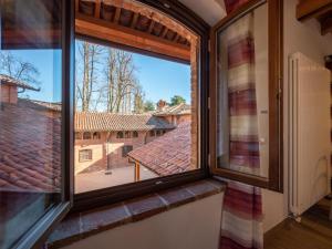 a window in a room with a view of a roof at Apartment Il Tiglio by Interhome in Mondovì