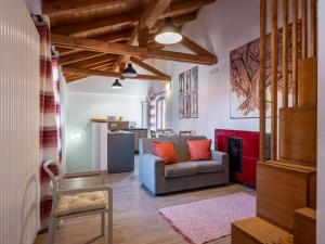 a living room with a couch and a chair at Apartment Il Tiglio by Interhome in Mondovì