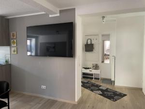 sala de estar con TV de pantalla plana en la pared en Wohnung am Markt - auch für Monteure gut geeignet, en Stendal