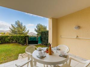 a white table and chairs on a patio at Apartment L'Esquinade - FH 012 by Interhome in Agay - Saint Raphael