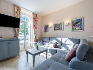 a living room with a couch and a tv at Apartment Villa Francia-2 by Interhome in Cannes