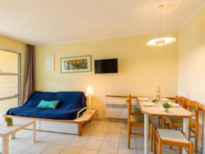 a room with a bed and a table and a dining room at Apartment L'Esquinade - FH 012 by Interhome in Agay - Saint Raphael +41 photos
