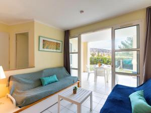 a living room with a couch and a table at Apartment L'Esquinade - FH 012 by Interhome in Agay - Saint Raphael