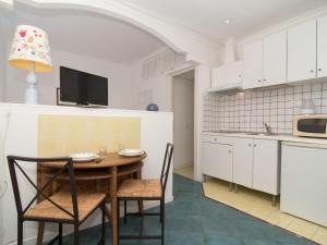 a kitchen with a table and chairs in a room at Apartment La Penultima-4 by Interhome in Ischia