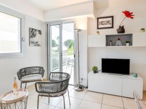 a living room with a tv and chairs at Apartment Dolce Vita by Interhome in Saint-Laurent-du-Var