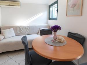 a living room with a table and a couch at Holiday Home Dubra by Interhome in Komarna +8 photos