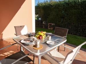 a table with a bowl of fruit on it at Holiday Home Alma by Interhome in Castiglione della Pescaia
