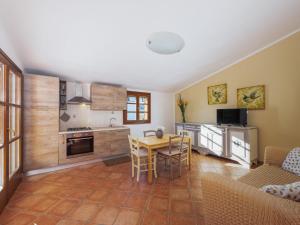 a kitchen and living room with a table and a couch at Holiday Home Alma by Interhome in Castiglione della Pescaia