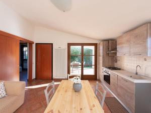 a kitchen with a wooden table with a vase on it at Holiday Home Alma by Interhome in Castiglione della Pescaia +12 photos