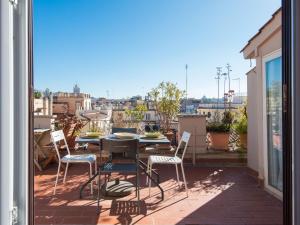a patio with a table and chairs on a balcony at Apartment Terrazza a Piazza di Spagna by Interhome in Rome